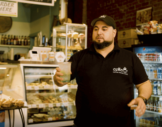Owner Joe Migdadi of Cello Coffee House and Cafe serving a drink