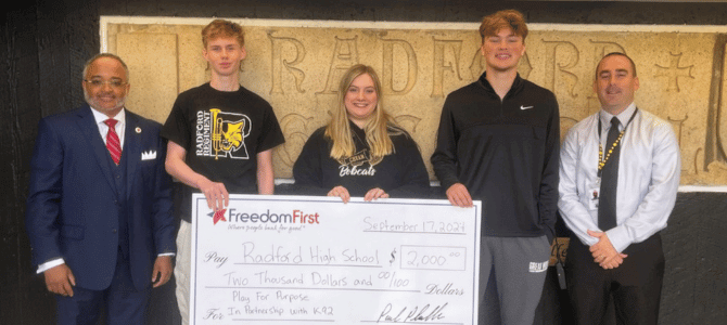 Radford High School students holding their Play for Purpose check from Freedom First