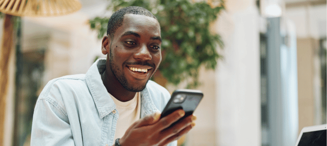 smiling man using his smartphone