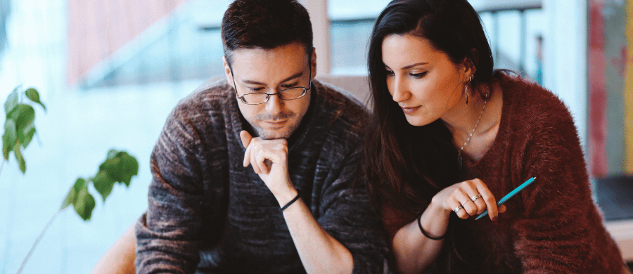 Man and woman looking over documents together