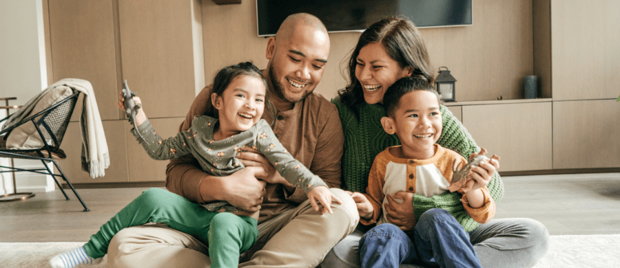 Smiling family of 4 in their home