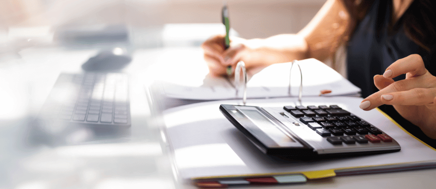 Woman using calculator to do taxes