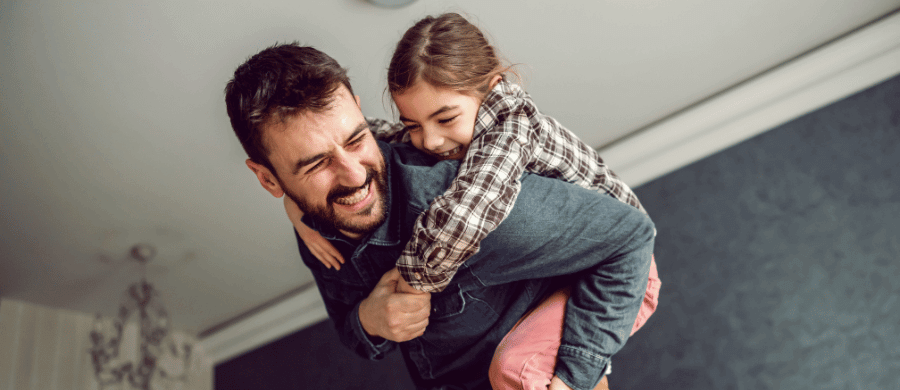 Father carrying daughter on his back