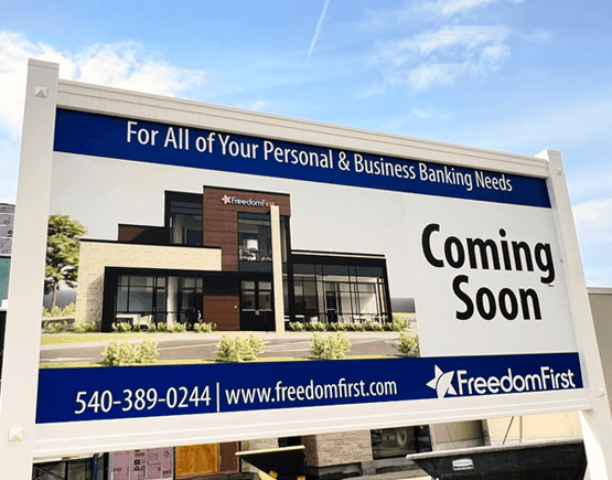 sign depicting renderings of new Freedom First branch with text saying coming soon