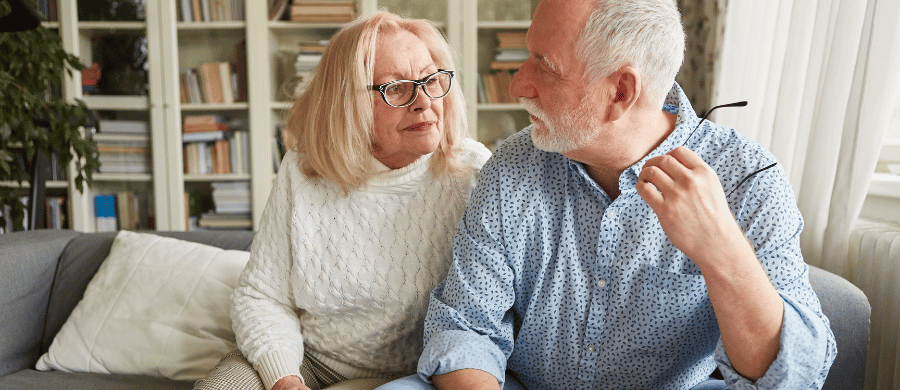 Elderly couple looking at each other