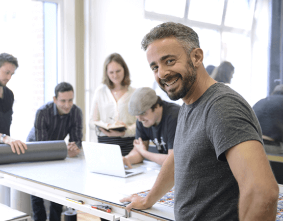 Smiling businessman in front of his team