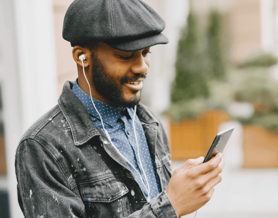 Young man listening to music and looking at his smartphone