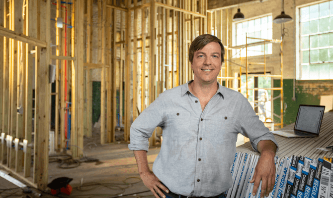 Entrepreneur Brent Cochran standing in construction site next to air filters