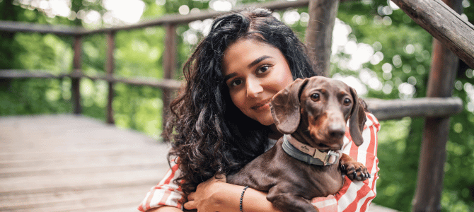 Young woman hugging her dog