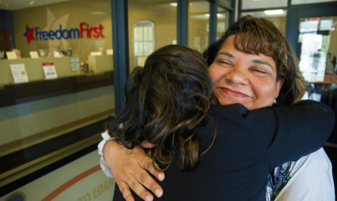 Freedom First member hugging an employee at a branch
