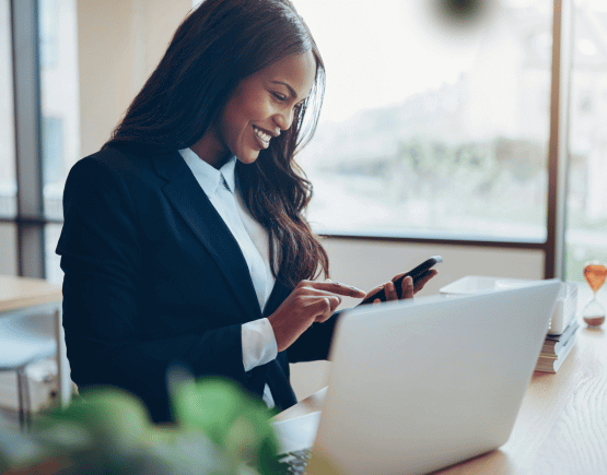 Young professional woman in a suit using her smartphone