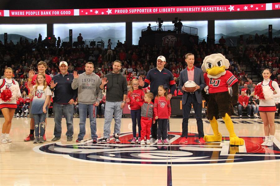 Freedom First employees on the court at a Liberty Flames basketball game