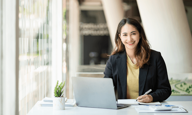 Smiling woman using a laptop