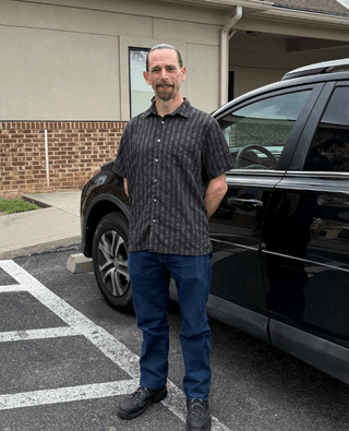 Man standing in front of a car