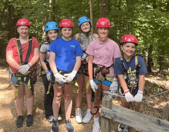 Group of summer camp participants in climbing gear