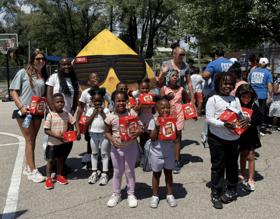 Schoolchildren showing Feeding SWVA donations they received
