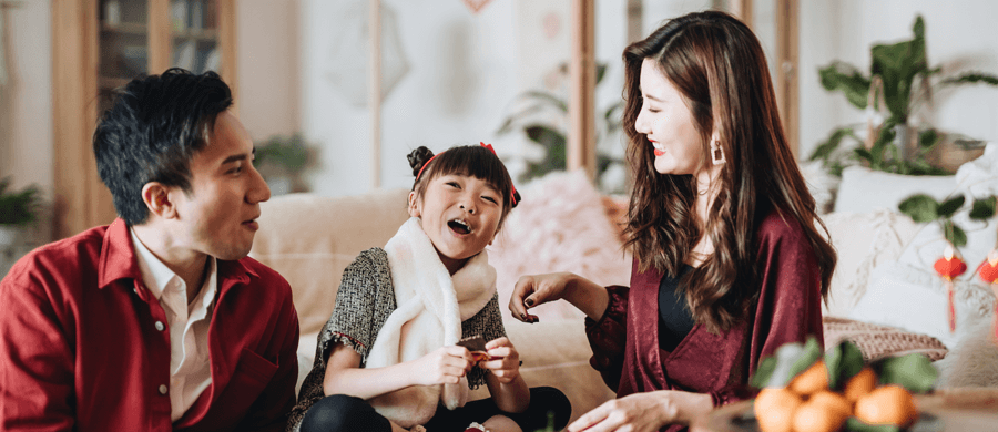 Young family of three celebrating Chinese New Year at home