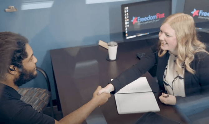 Kayla Adams shaking hands with a client