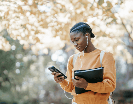 Student listening to music and looking at their smartphone