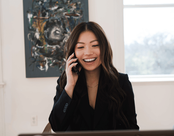 Smiling young woman speaking on a smartphone
