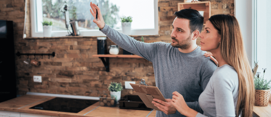 Man and woman evaluating their kitchen