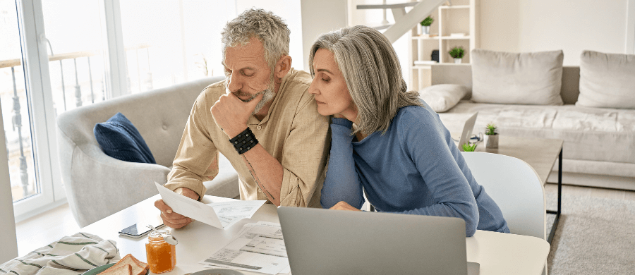 Older couple reviewing finances in their living room