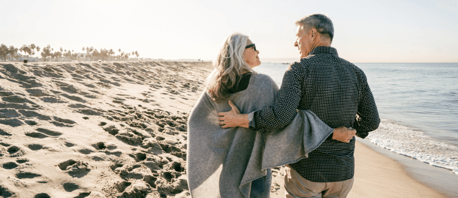 Older couple walking along the beach