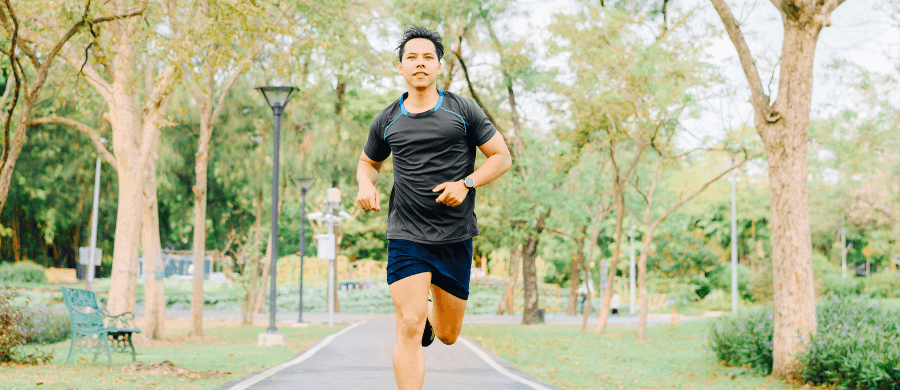 Fit young man jogging in a park