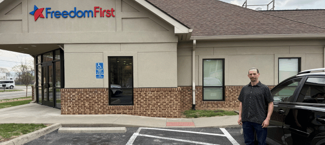 Responsible Rides client with his car in front of a Freedom First branch