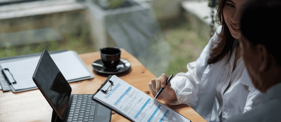 Woman reviewing health insurance options with an older man