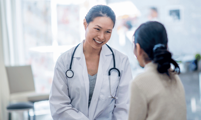 Young female doctor speaking with patient